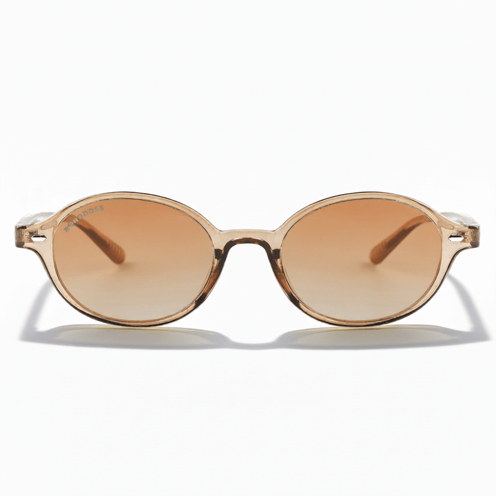 vista frontal de lentes de sol ovalados color champagne con lentes degradé cafe. Lentes ovalados retro de moda para hombre y mujer #color_champagne