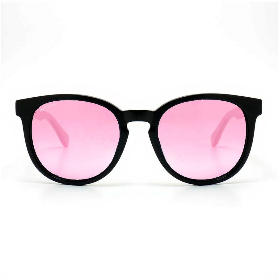 anteojos redondos de plástico reciclado y varillas de madera natural sustentable con lentes de color rosado polarizadas y forma redonda. 