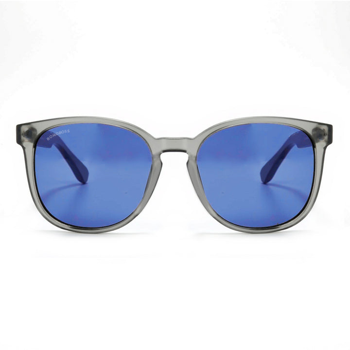 anteojos redondos de plástico reciclado y varillas de madera natural sustentable con lentes de color rosado. Polarizadas y forma redonda. La gafa es color transparente #color_degrade-azul