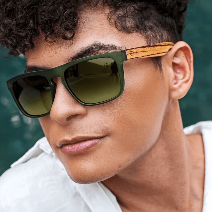una vista frontal de anteojos gafas de sol rectangulares ecologicas de plastico reciclado especial para regalo corporativo personalizado de color verde blanco con lentes degrade verde en vista angulada en un modelo hombre #color-marco_forest