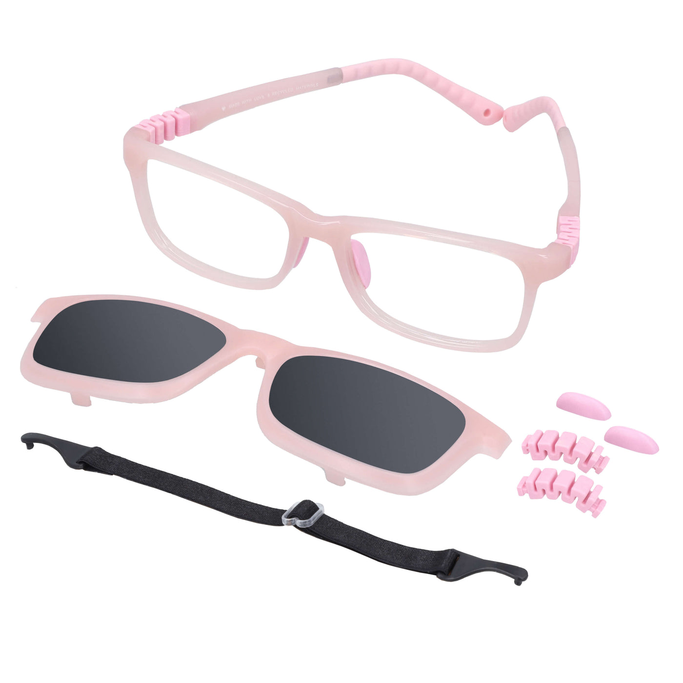 anteojos ópticos con receta para niños y niñas de forma rectangular y clip para el sol polarizado. En la parte inferior de la foto se ve un strap o colgante para los anteojos y en la parte derecha repuestos de las bisagras y de los nosepads. El anteojo es de color rosado y es una vista angulada desde arriba