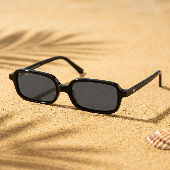 Lentes sol Navarino polarizados UV400 sobre arena dorada costa textura natural Bonoboss #color_negro