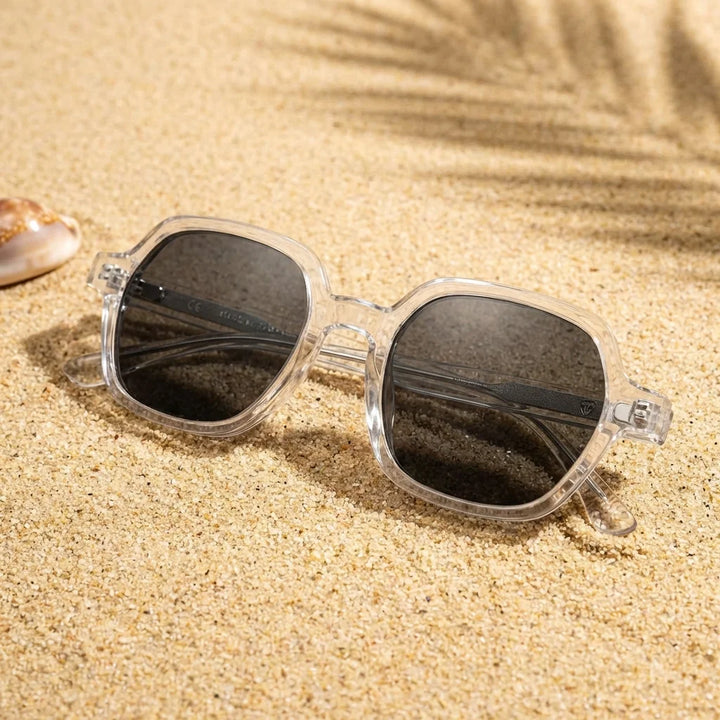 Lentes sol Canarias polarizados UV400 sobre arena dorada costa textura natural Bonoboss #color_transparente