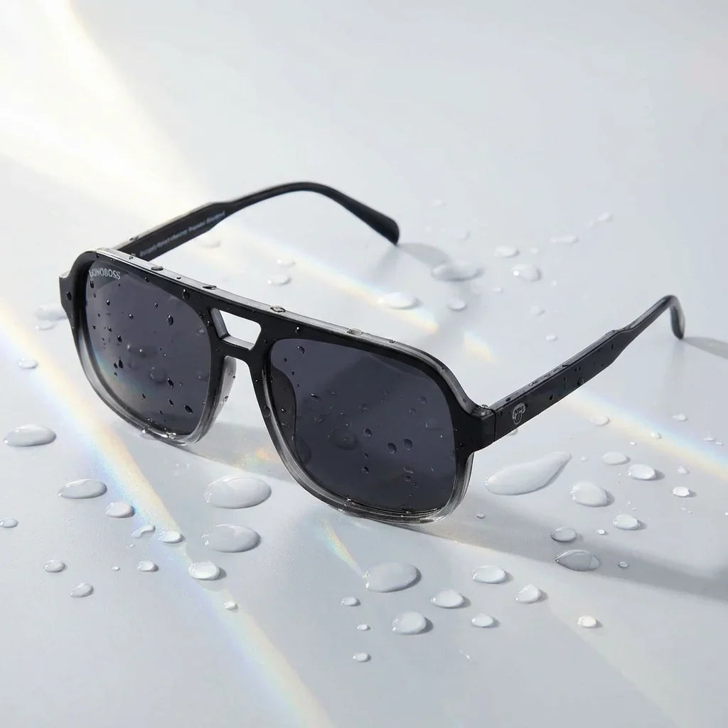 Lentes sol Orson RPET polarizados UV400 sobre superficie con agua y luz natural Bonoboss #color_negro