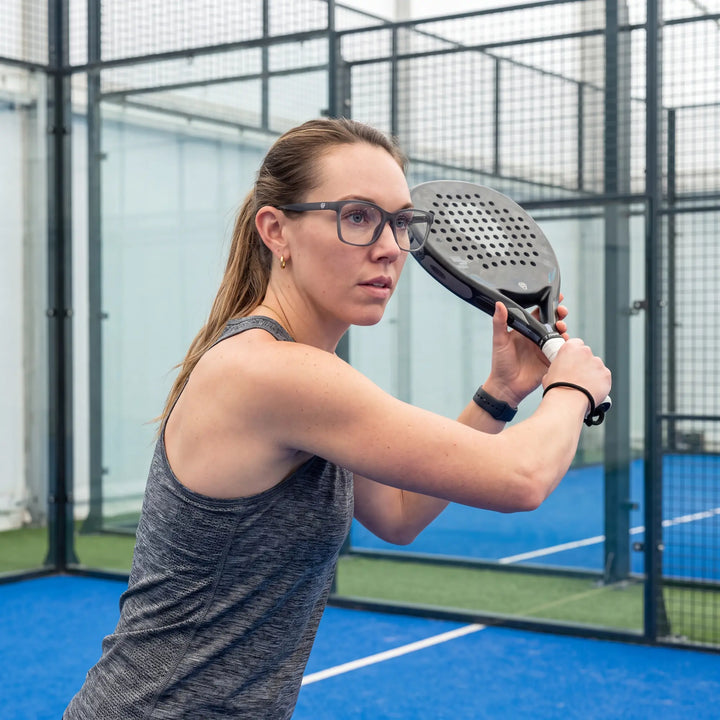 Lentes ópticos deportivos Bonoboss Comaneci Azul, mujer practicando pádel al aire libre con el armazón puesto #editorial_modelo6 #color_azul