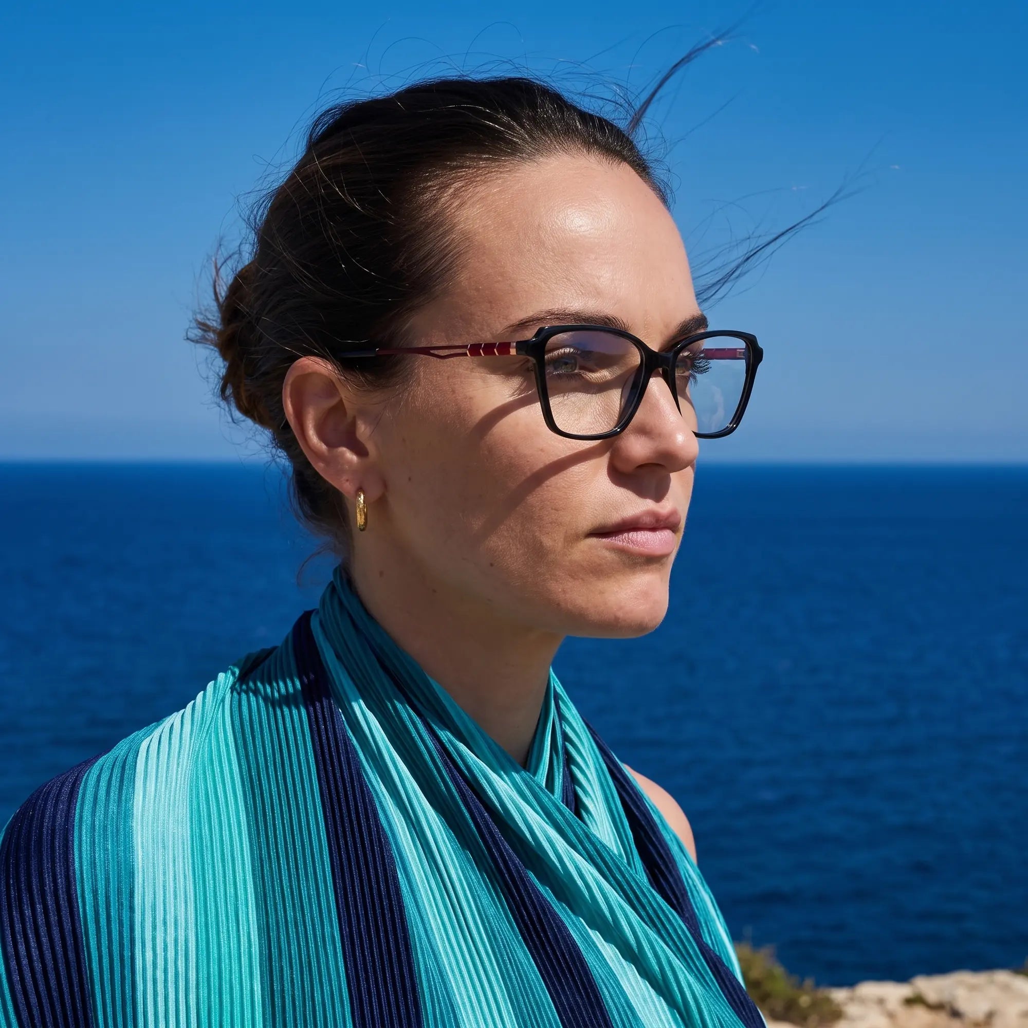 Anteojos Fiore 1006 en negro, en modelo – retrato de campaña, retrato al viento sobre el mar azul profundo