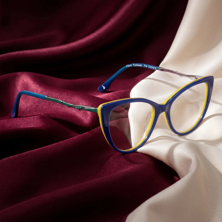 Anteojos Fiore 1010 en blue green – resting on draped burgundy and ivory silk