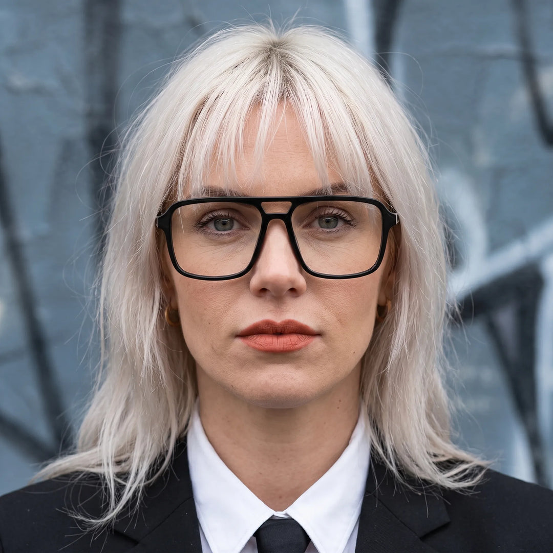 Anteojos Fiore 1014 en negro, en modelo – retrato de campaña, confident portrait with gold chain necklace