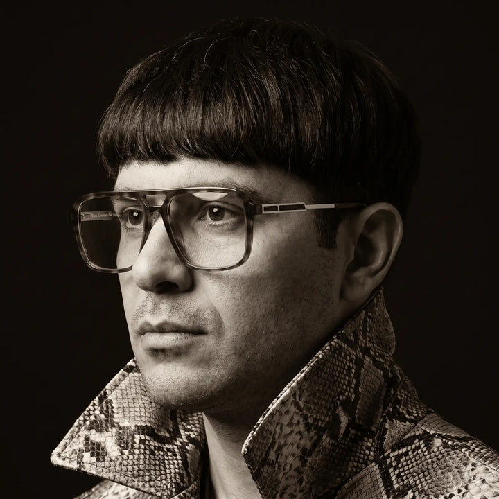 Anteojos Fiore 1014 en brown tortoiseshell, en modelo – monochrome studio portrait, red graphic accents
