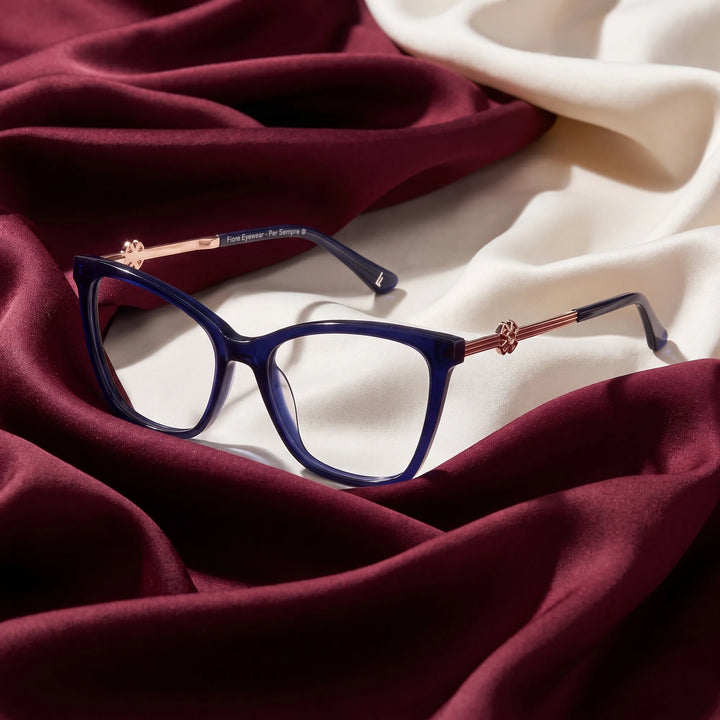 Anteojos Fiore 10172 en azul – resting on draped burgundy and ivory silk