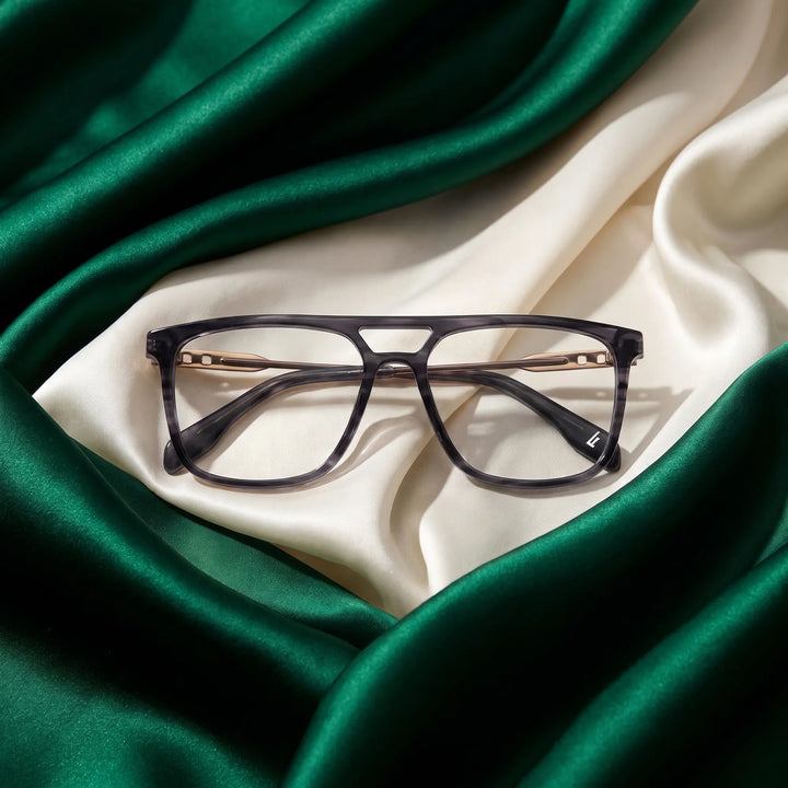 Anteojos Fiore 10177 en gris – resting on draped emerald and ivory silk