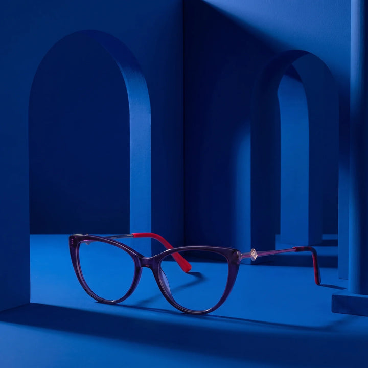 Anteojos Fiore 1031 en morado verde – staged on a sculptural cobalt architecture set
