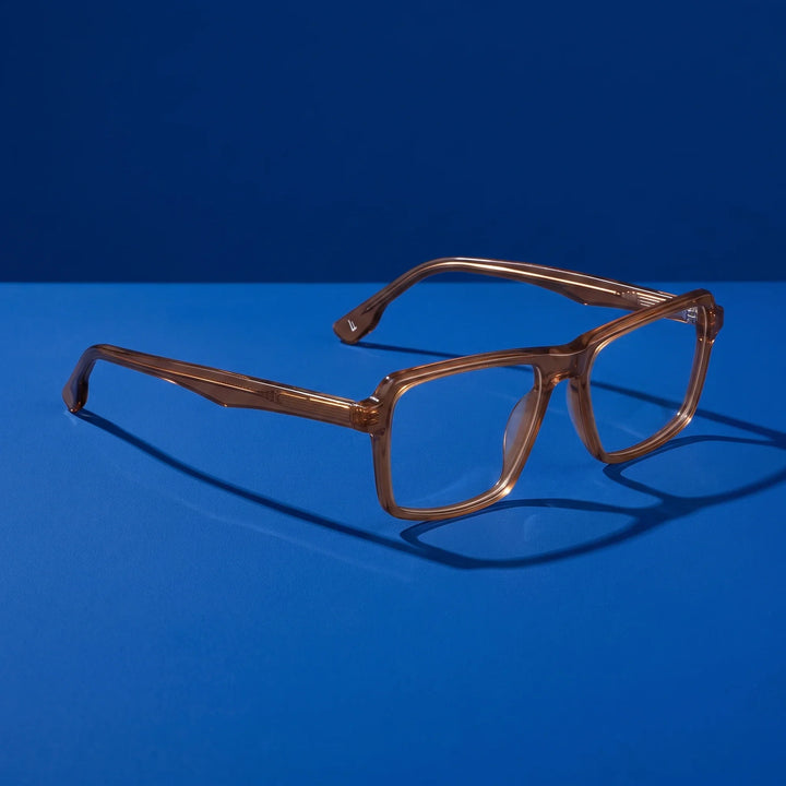 Anteojos Fiore 1038 en café – hero still life against a deep cobalt backdrop