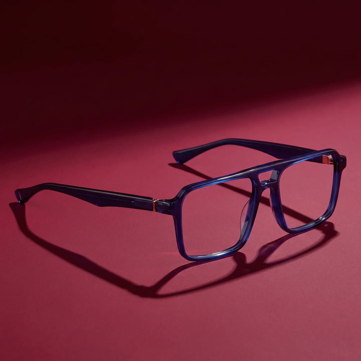 Anteojos Fiore 1039 en azul – editorial still life on a saturated burgundy set