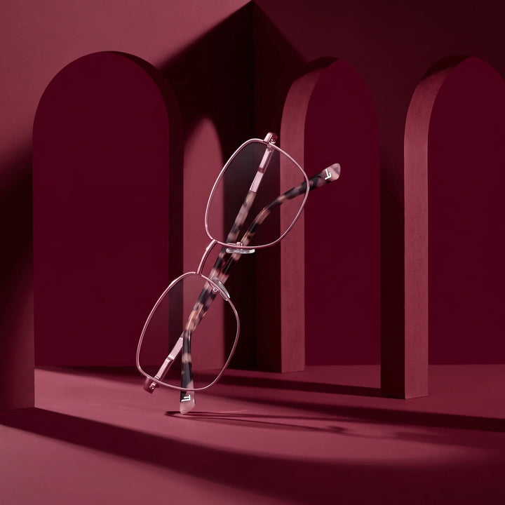 Anteojos Fiore 2210 en rosa – still life among monochrome burgundy arches