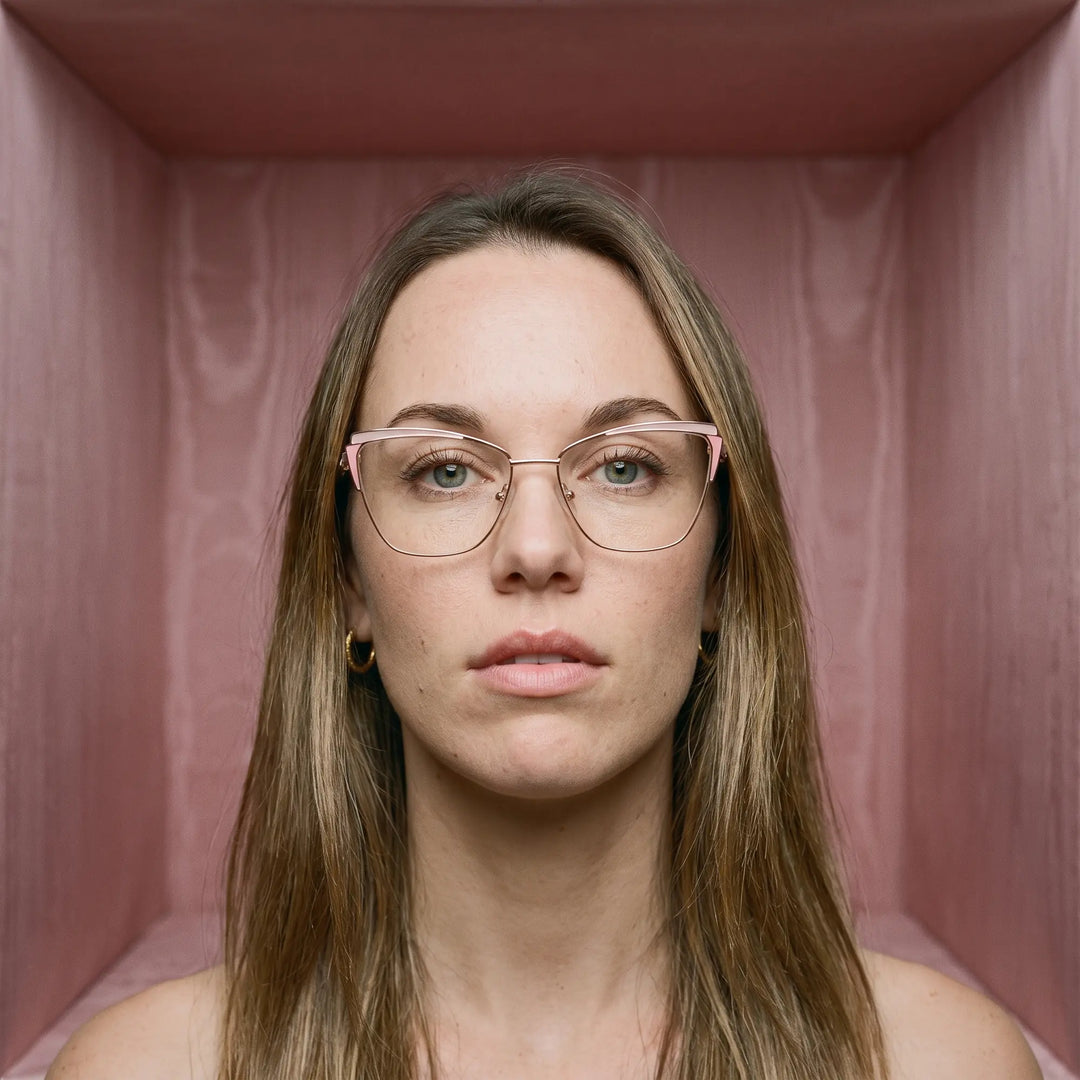 Anteojos Fiore 3837 en rosado dorado, en modelo – retrato de campaña, face framed by rose moire upholstery