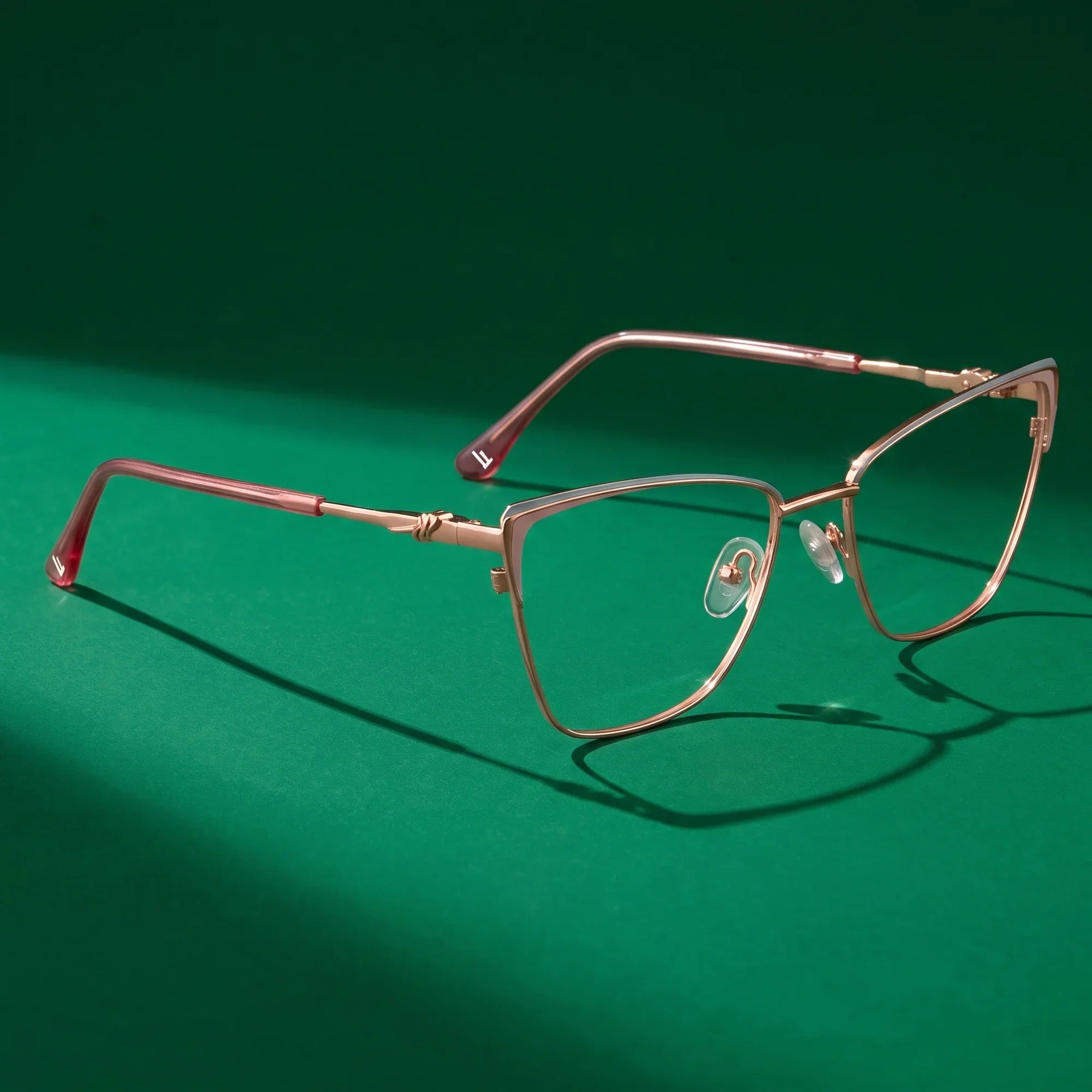 Anteojos Fiore 3839 en pink gold – bodegón editorial sobre un set esmeralda saturado