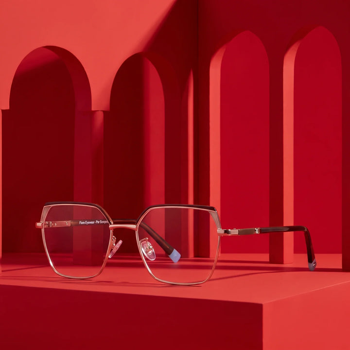 Anteojos Fiore 3971 en brown gold – staged on a sculptural vivid red architecture set