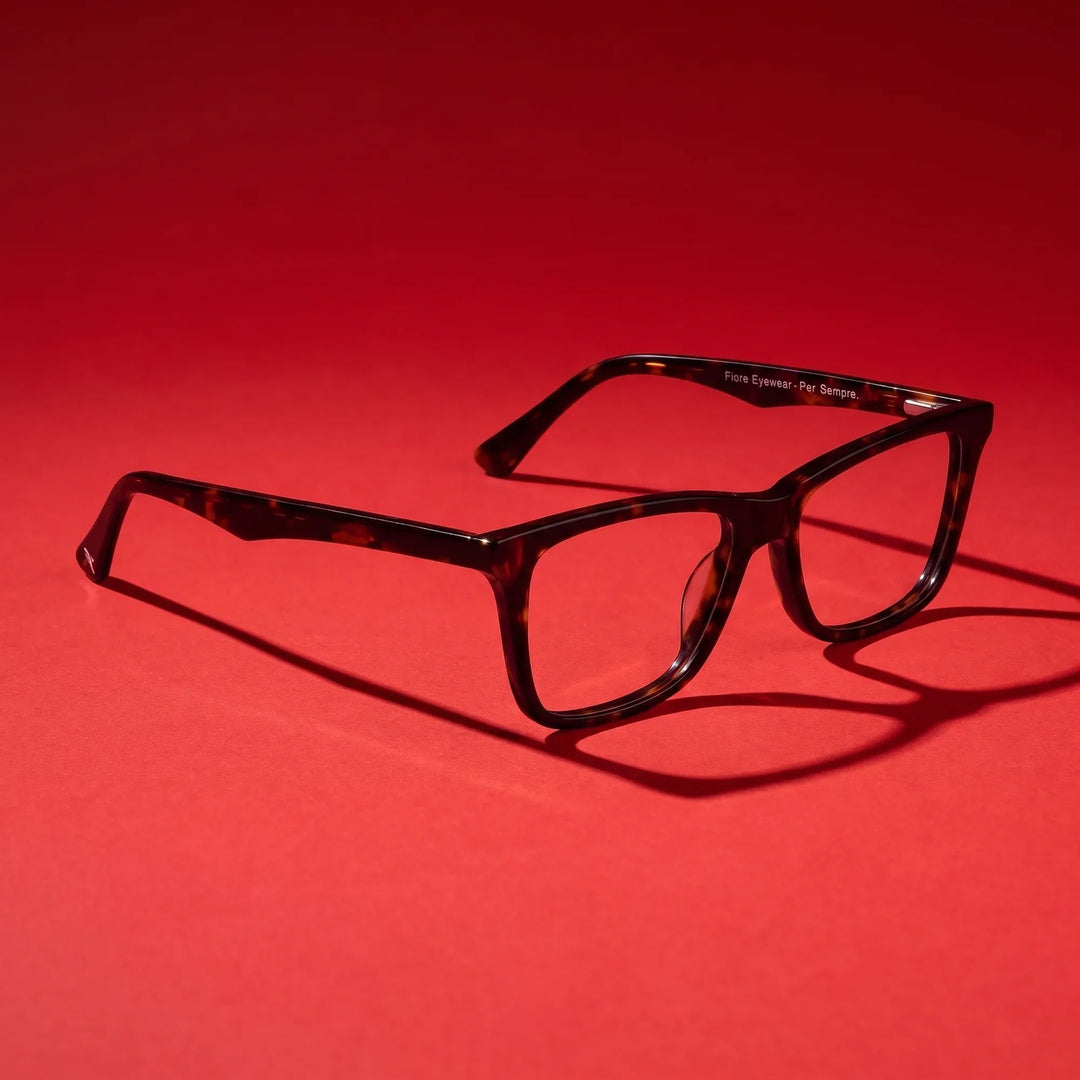Anteojos Fiore 5228 en carey – editorial still life on a saturated vivid red set