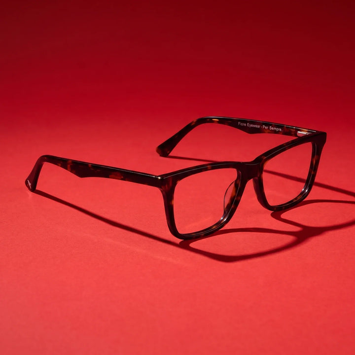 Anteojos Fiore 5228 en carey – editorial still life on a saturated vivid red set