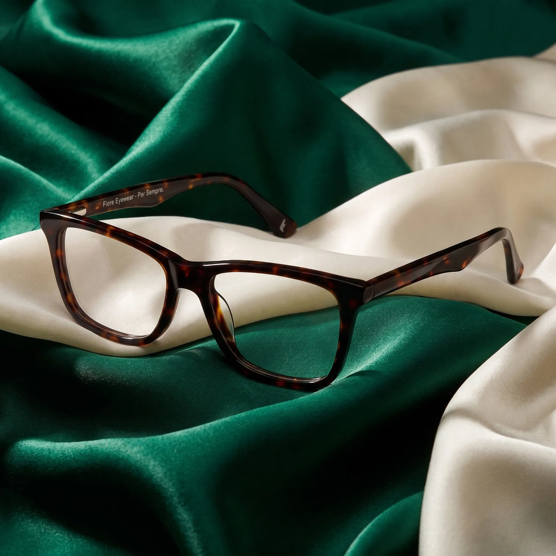 Anteojos Fiore 5228 en tortoiseshell – resting on draped emerald and ivory silk