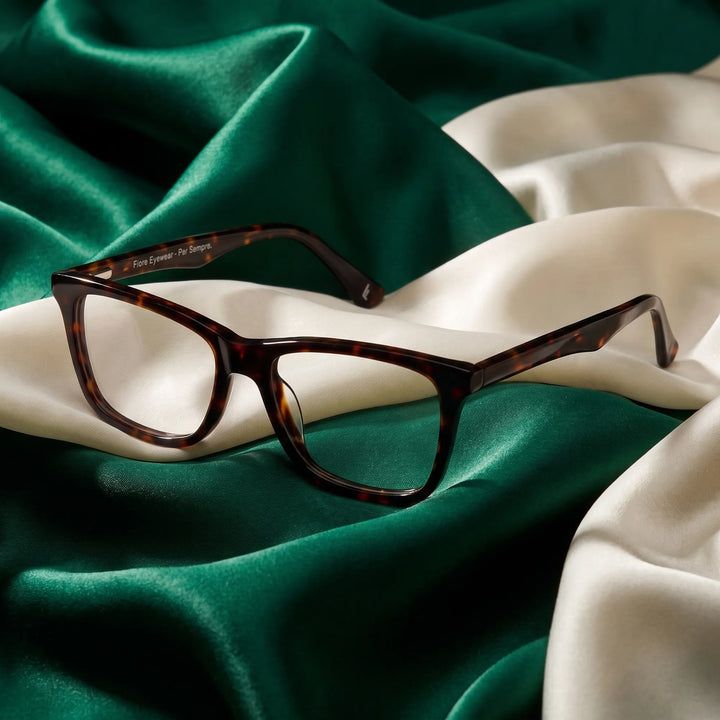 Anteojos Fiore 5228 en tortoiseshell – resting on draped emerald and ivory silk