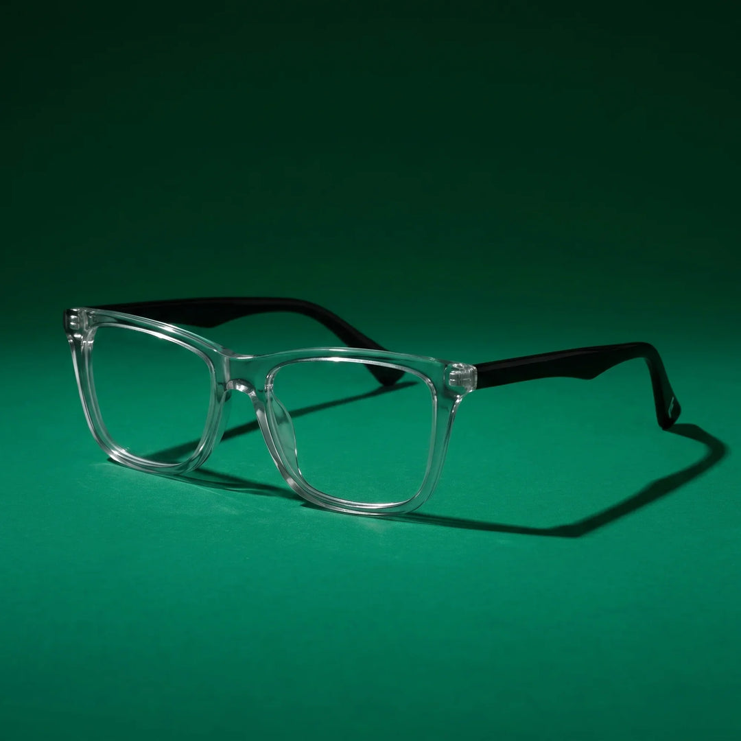 Anteojos Fiore 5228 en transparente – still life on a seamless emerald studio backdrop