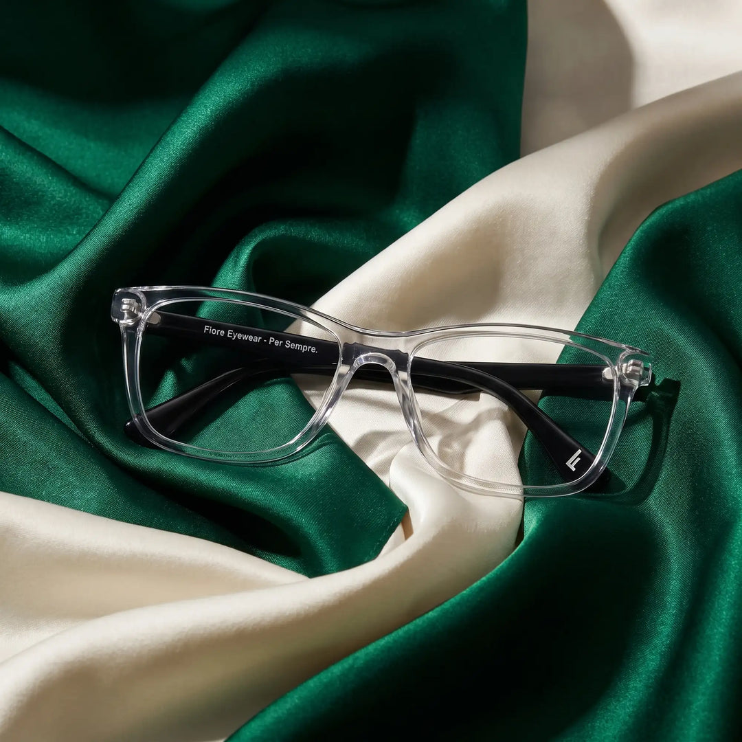 Anteojos Fiore 5228 en transparent – resting on draped emerald and ivory silk