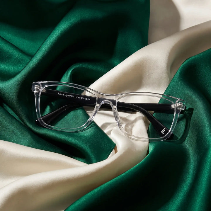 Anteojos Fiore 5228 en transparent – resting on draped emerald and ivory silk