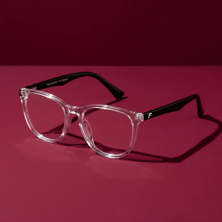 Anteojos Fiore 7046 en transparent – editorial still life on a saturated burgundy set