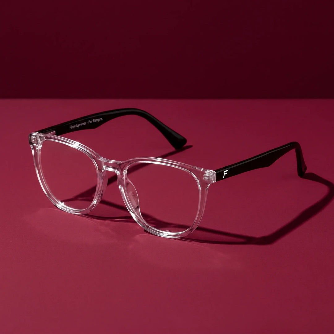Anteojos Fiore 7046 en transparente – editorial still life on a saturated burgundy set