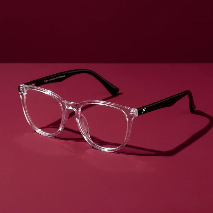 Anteojos Fiore 7046 en transparente – editorial still life on a saturated burgundy set