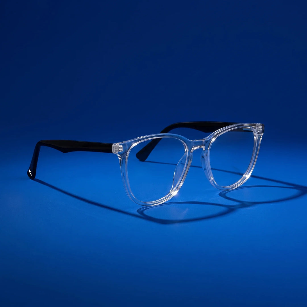 Anteojos Fiore 7046 en transparent – hero still life against a deep cobalt backdrop