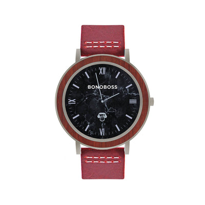 reloj de acero inoxidable plateado con correa de cuero intercambiable roja y fondo negro marmoleado