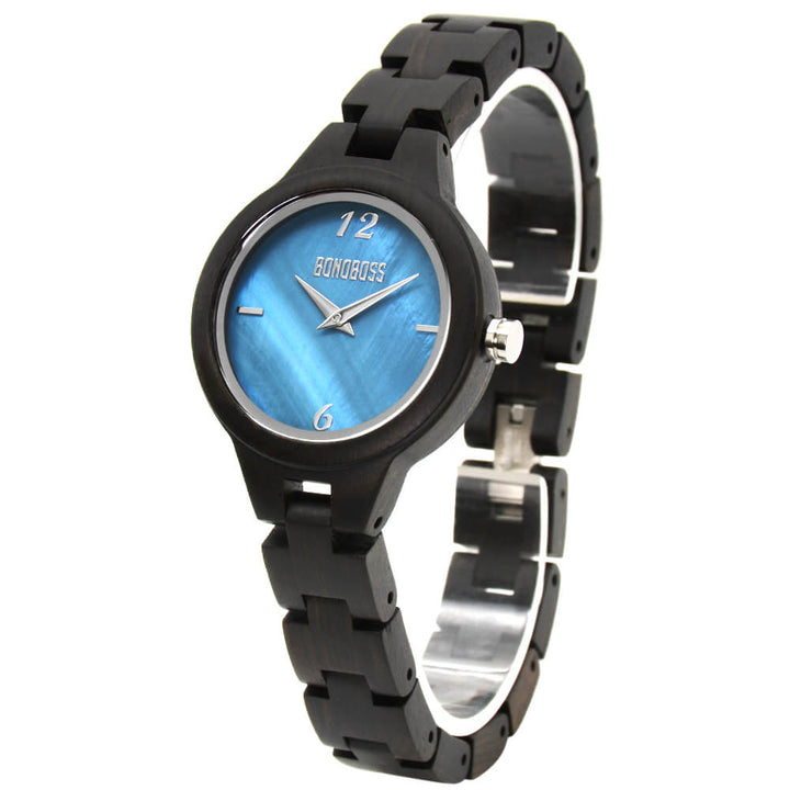 reloj de madera para mujer en sandalo negro y fondo de nacar o concha de mar natural